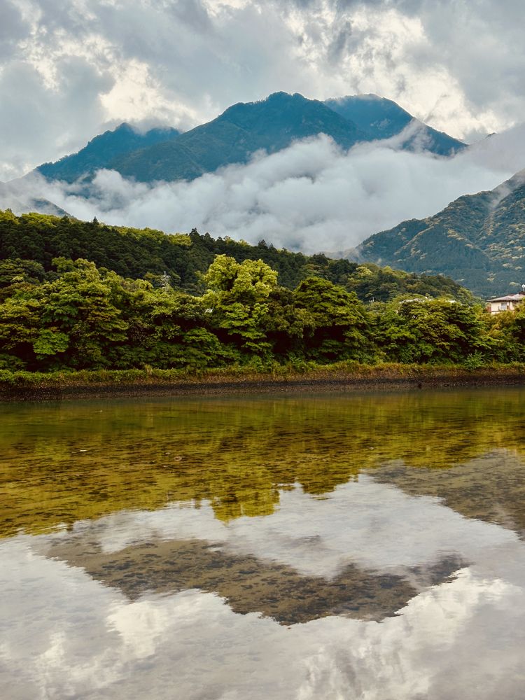 Misty mountains reflected in still water